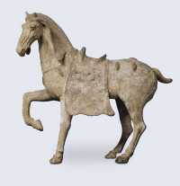 TANG DYNASTY (618-907) A PAINTED POTTERY FIGURE OF A CAPARISONNED HORSE